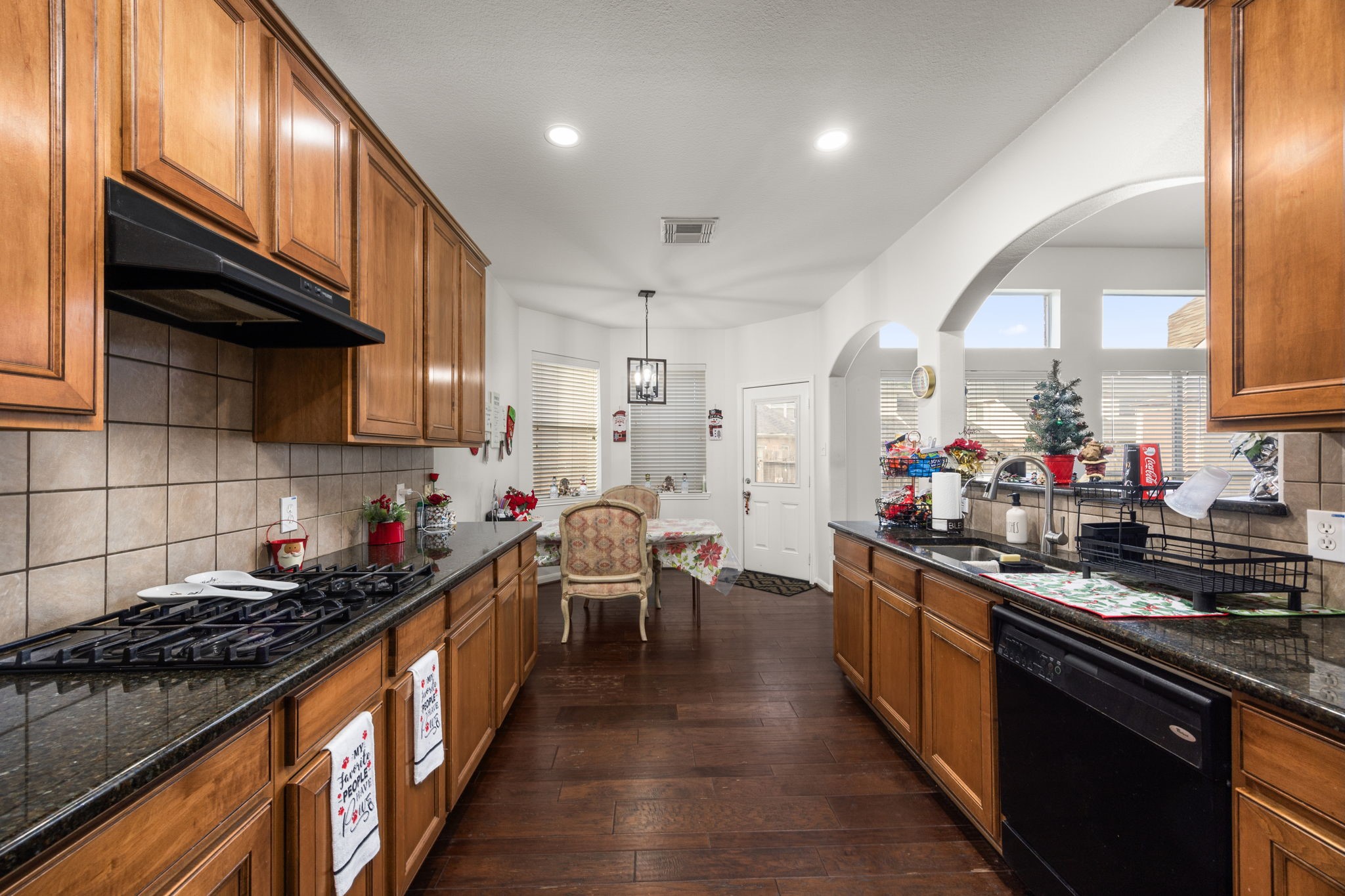 927 Spring Source Place Spring, TX 77373 - Photo 16 of 37 a kitchen with lots of counter top space and wooden floor