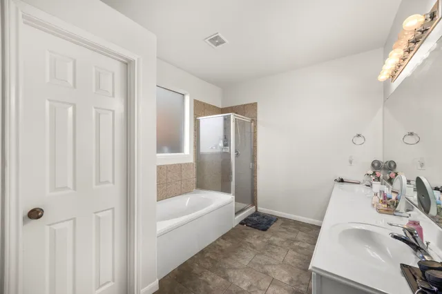 a bathroom with a tub and sink