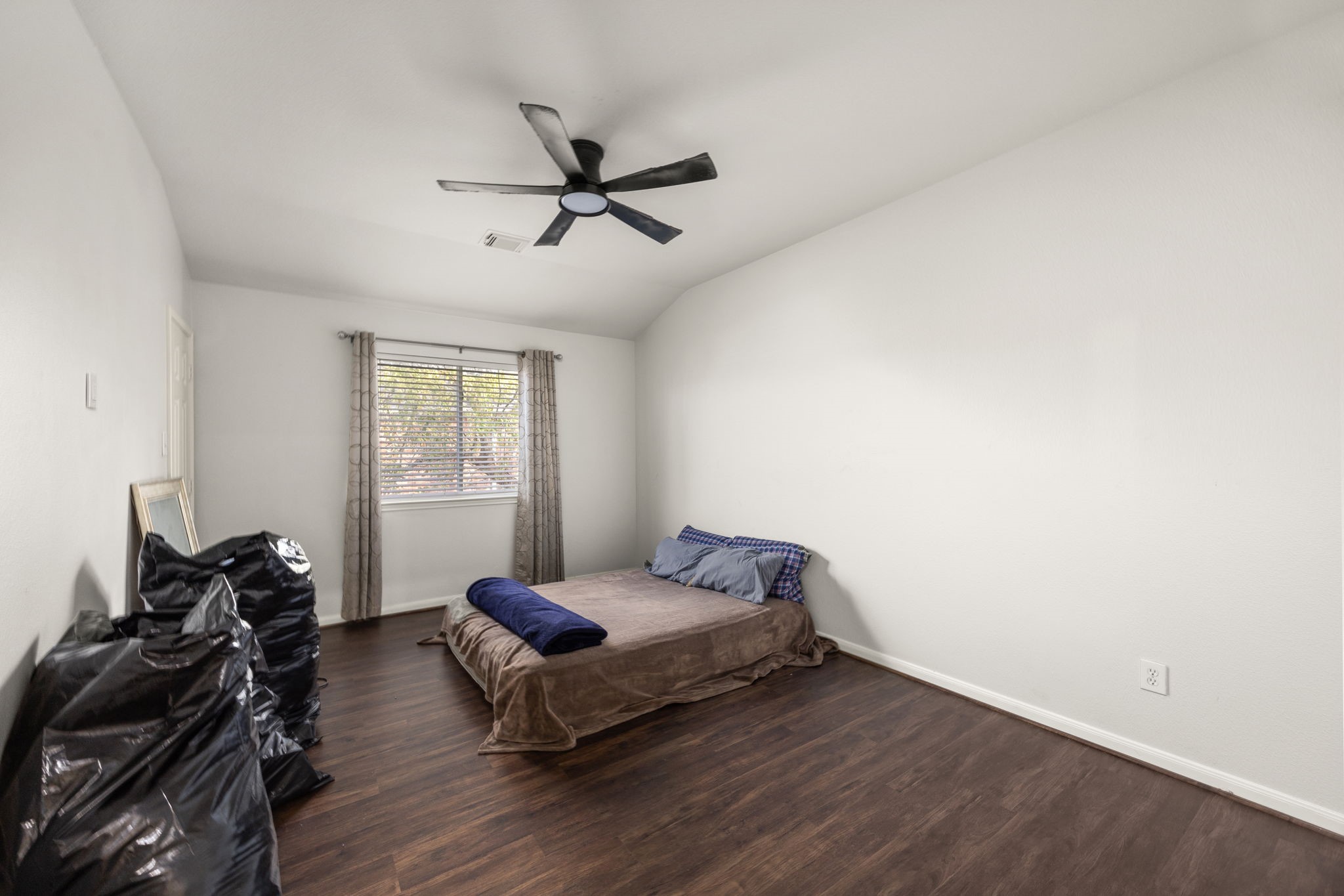 927 Spring Source Place Spring, TX 77373 - Photo 22 of 37 a bedroom with a bed and wooden floor