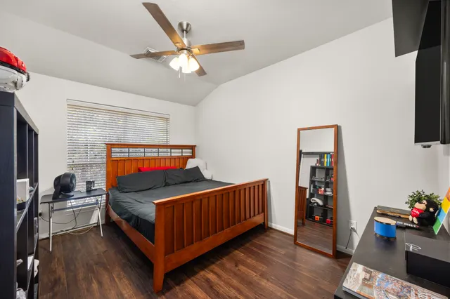 a bedroom with furniture and a flat screen tv