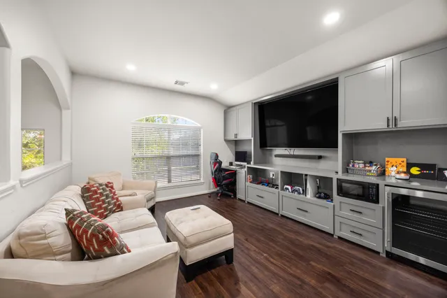 a living room with furniture and a flat screen tv