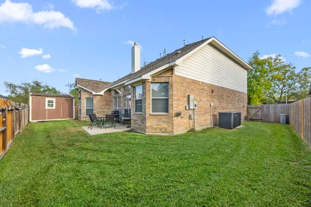 a view of a house with a yard and deck