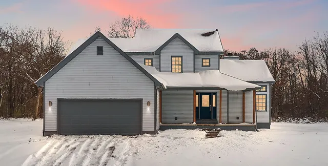 a view of a house with a yard and garage