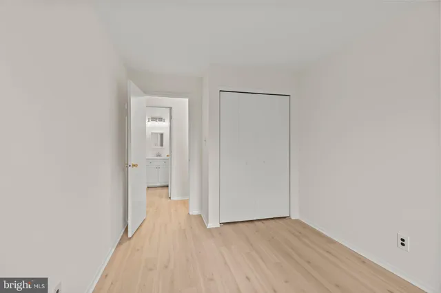 a view of a room with wooden floor and a bathroom