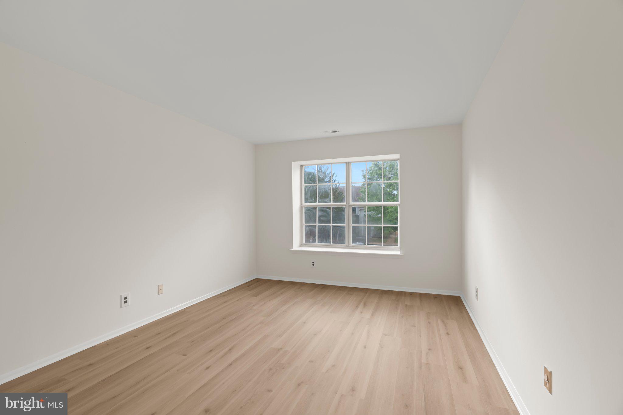 330 B Delancey Place Mount Laurel, NJ 08054 - Photo 16 of 21 an empty room with wooden floor and windows