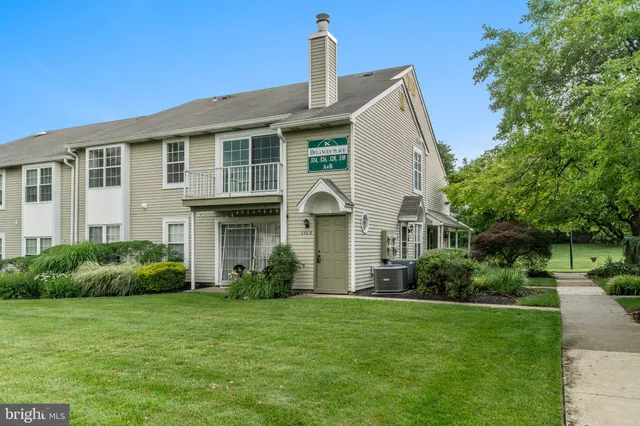 a front view of house with a garden