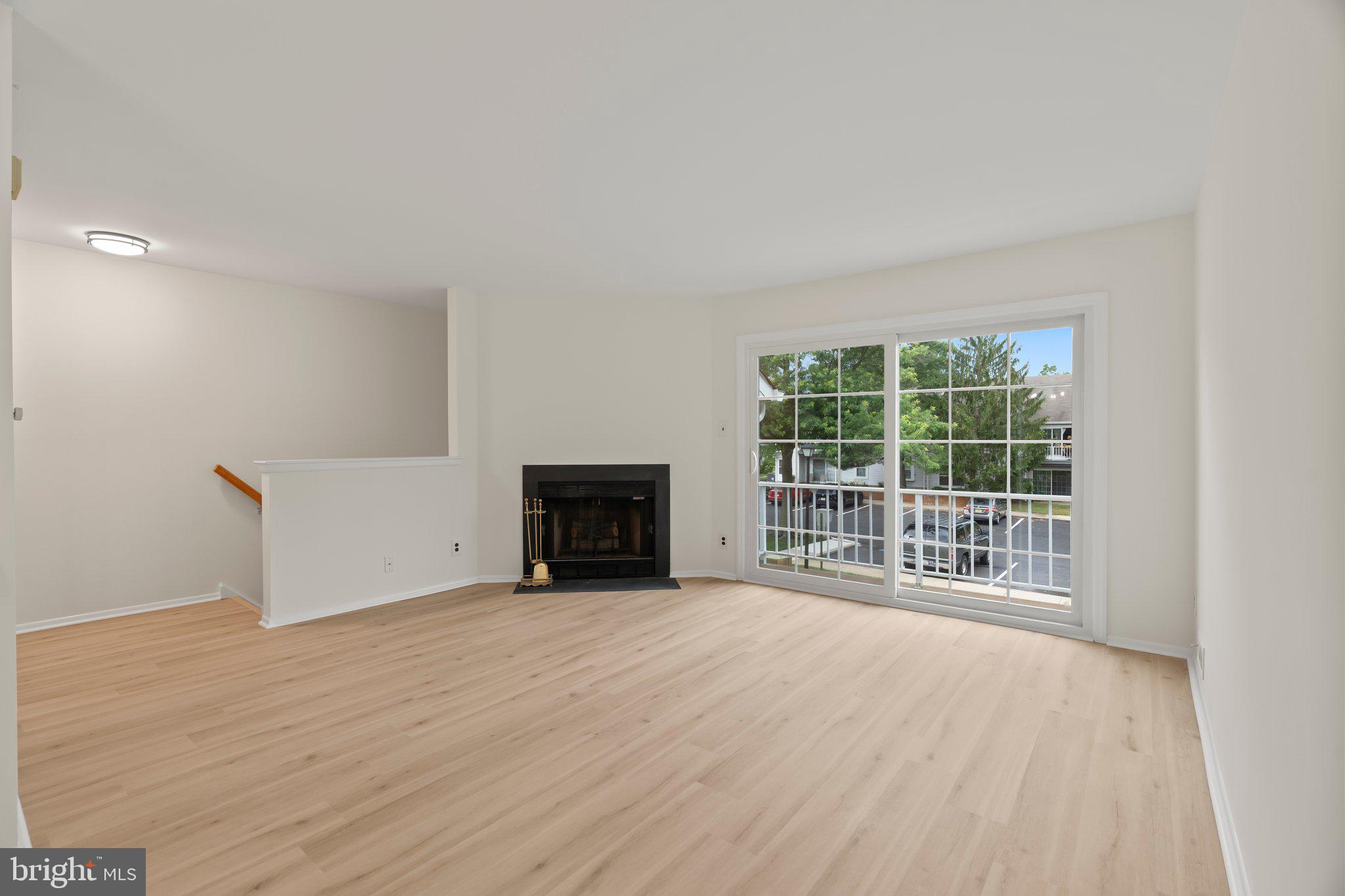 330 B Delancey Place Mount Laurel, NJ 08054 - Photo 4 of 21 a view of an empty room with a fireplace and a window