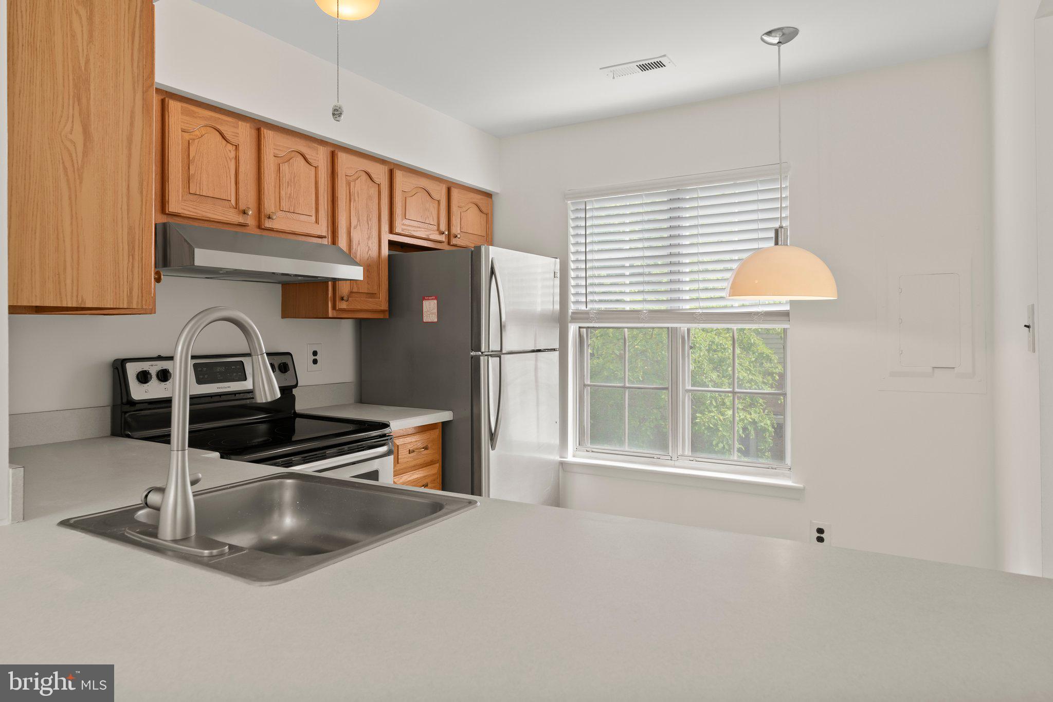 330 B Delancey Place Mount Laurel, NJ 08054 - Photo 8 of 21 a kitchen with stainless steel appliances granite countertop a sink and a window