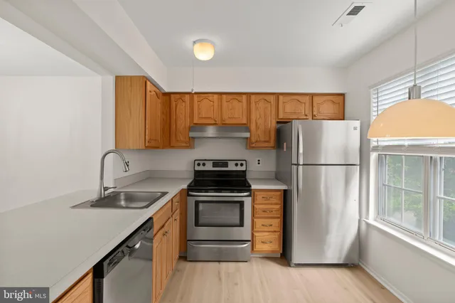 a kitchen with a refrigerator sink and stove