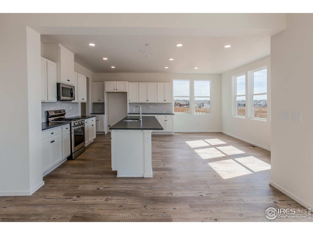 6642 4th St Road Greeley, CO 80634 - Photo 12 of 40 KITCHEN AND DINING ROOM