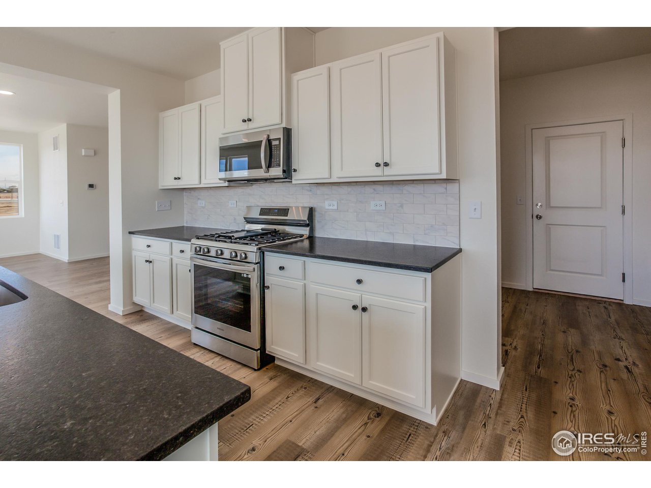 6642 4th St Road Greeley, CO 80634 - Photo 13 of 40 KITCHEN W/ SS APPLIANCES (FRIDGE NOT INCLUDED