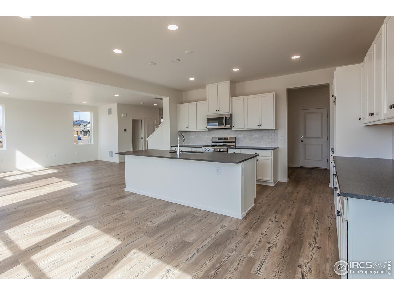 6642 4th St Road Greeley, CO 80634 - Photo 14 of 40 KITCHEN, LIVING AND DINING ROOM