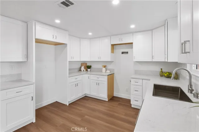 a bedroom with a large bed and a potted plant