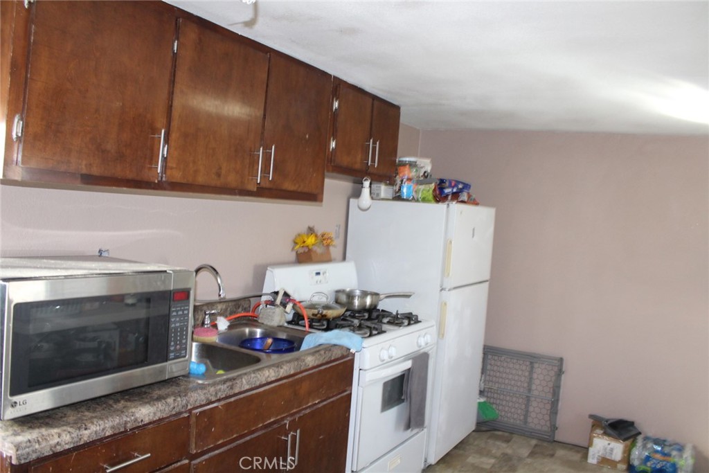 12543 Buckwheat Road Phelan, CA 92371 - Photo 16 of 37 a kitchen with a stove and a microwave