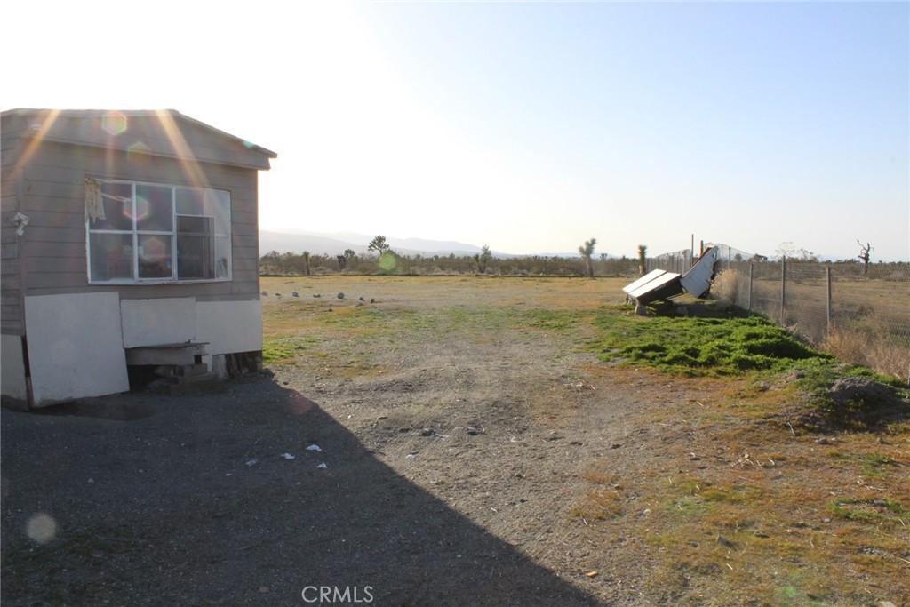 12543 Buckwheat Road Phelan, CA 92371 - Photo 20 of 37 a view of a dry yard with a house