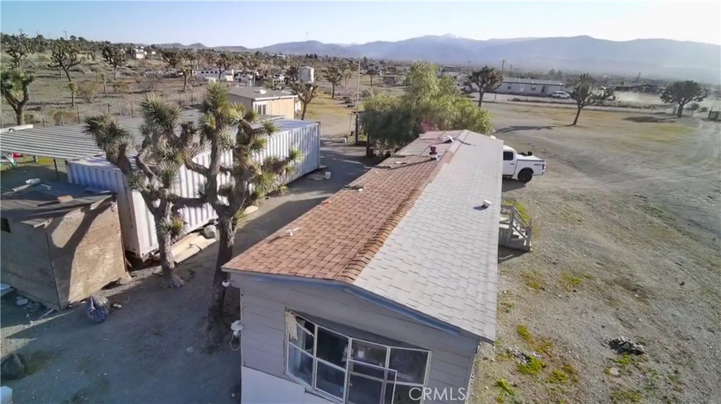 12543 Buckwheat Road Phelan, CA 92371 - Photo 32 of 37 a view of a house with a mountain yard