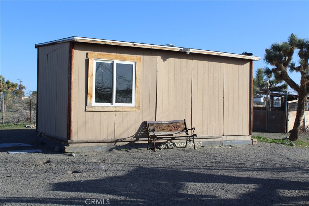 12543 Buckwheat Road Phelan, CA 92371 - Photo 4 of 37 a backyard of a house with table and chairs