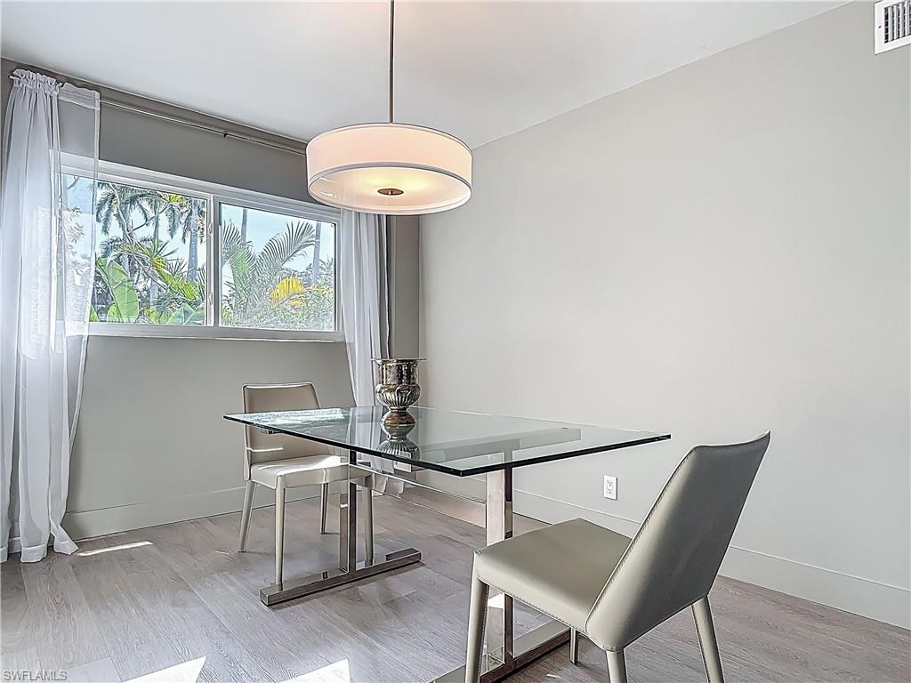 2544 First Street, Unit 102 Fort Myers, FL 33901 - Photo 11 of 26 a view of a dining room with furniture window and wooden floor