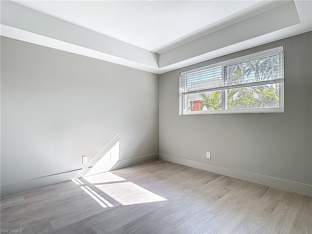 2544 First Street, Unit 102 Fort Myers, FL 33901 - Photo 22 of 26 an empty room with wooden floor and windows