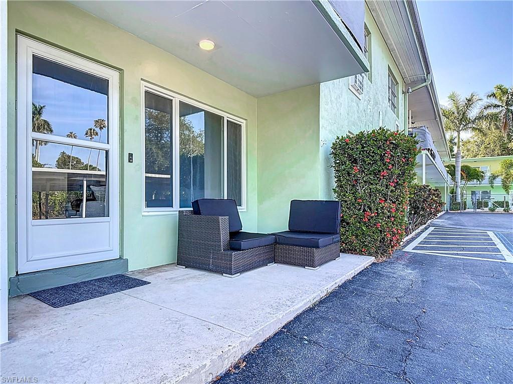 2544 First Street, Unit 102 Fort Myers, FL 33901 - Photo 3 of 26 a view of a porch with chairs and potted plants