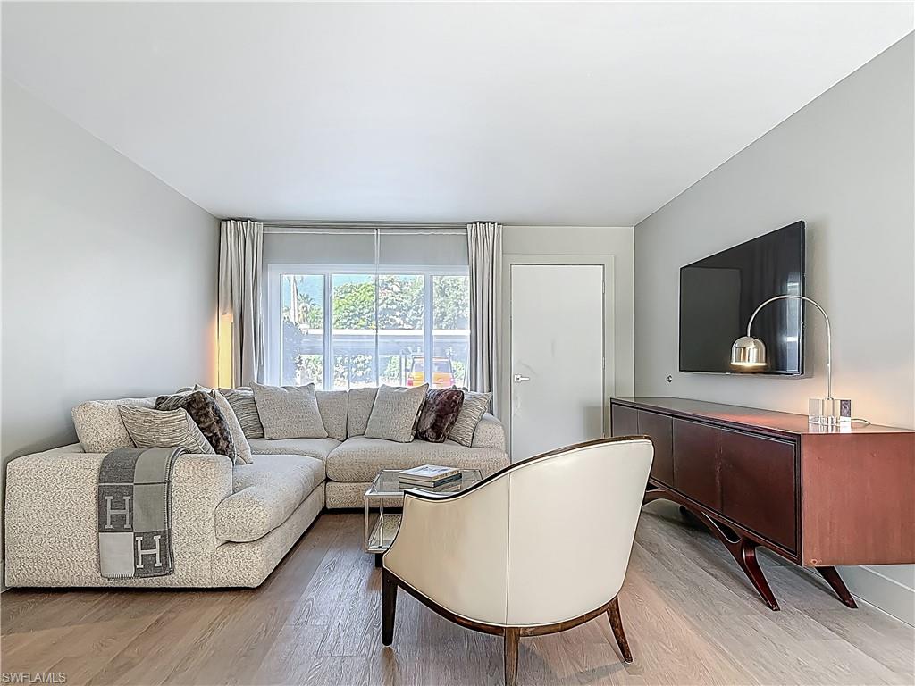 2544 First Street, Unit 102 Fort Myers, FL 33901 - Photo 5 of 26 a living room with furniture and a flat screen tv