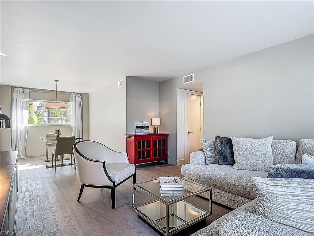 2544 First Street, Unit 102 Fort Myers, FL 33901 - Photo 8 of 26 a living room with furniture and a wooden floor