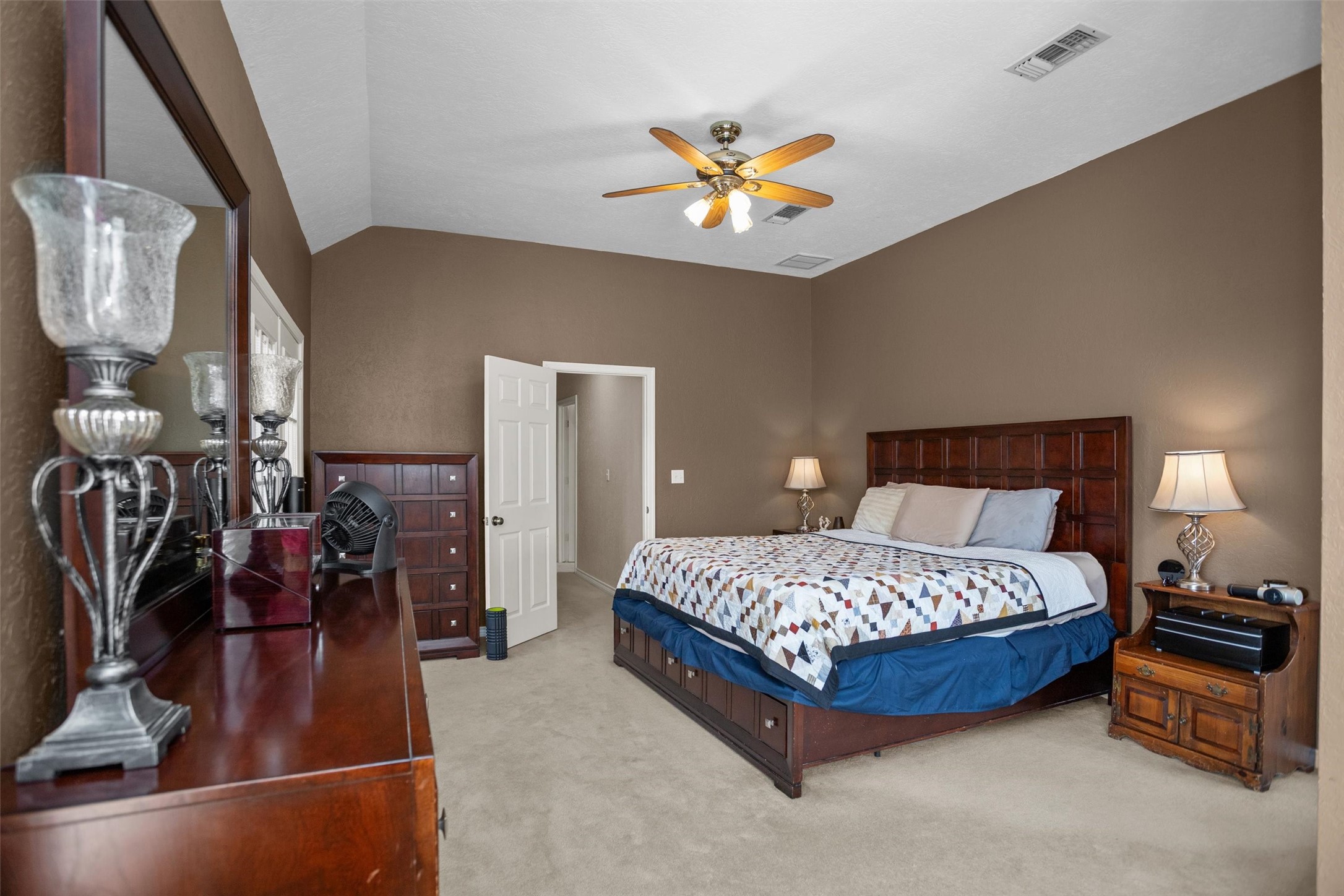 2101 San Antonio Road Crockett, TX 75835 - Photo 19 of 37 a bedroom with a bed and a chandelier