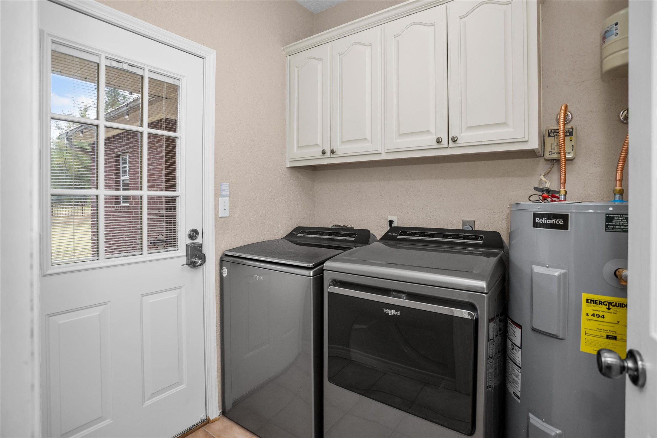 2101 San Antonio Road Crockett, TX 75835 - Photo 30 of 37 a utility room with stainless steel appliances wooden cabinets washer and dryer