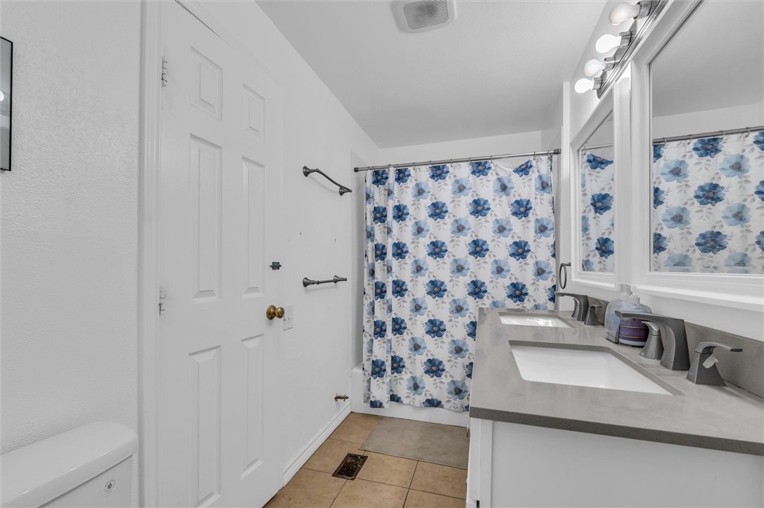 1940 East Highland Road Waxahachie, TX 75167 - Photo 16 of 44 a bathroom with a sink toilet and shower