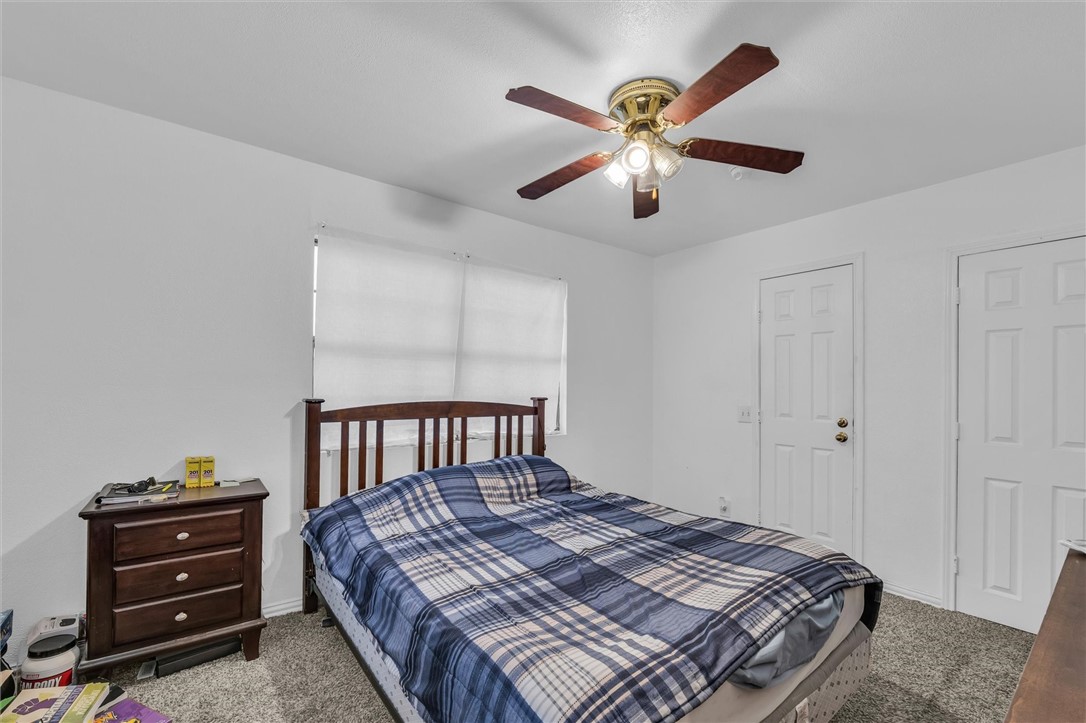 1940 East Highland Road Waxahachie, TX 75167 - Photo 34 of 44 a bedroom with a bed and a chandelier