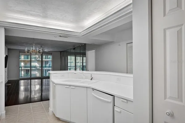 a kitchen with stainless steel appliances a sink stove and white cabinets