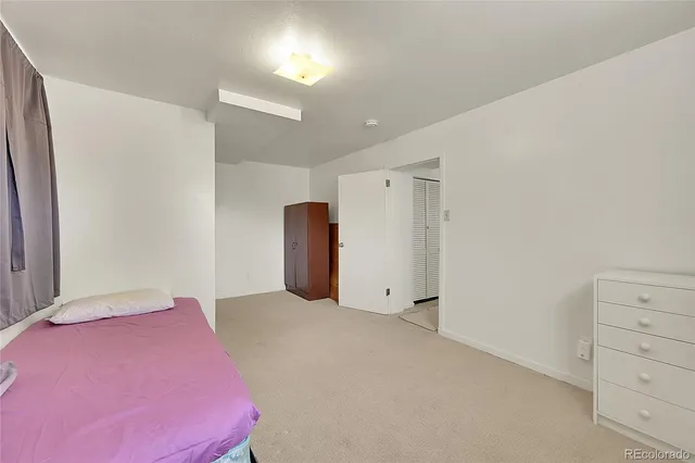 a bedroom with a bed and cabinets