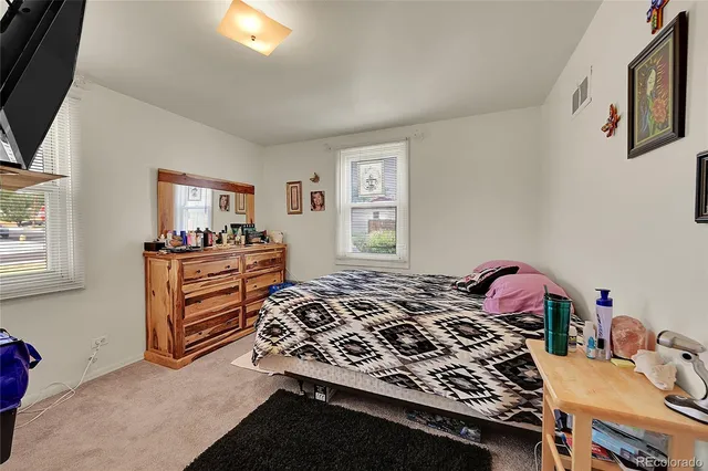 a bedroom with a bed and a dresser