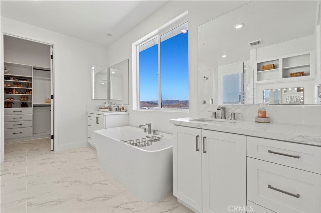 30015 Chestnut Lane Castaic, CA 91384 - Photo 29 of 60 a bathroom with a sink double vanity and a shower