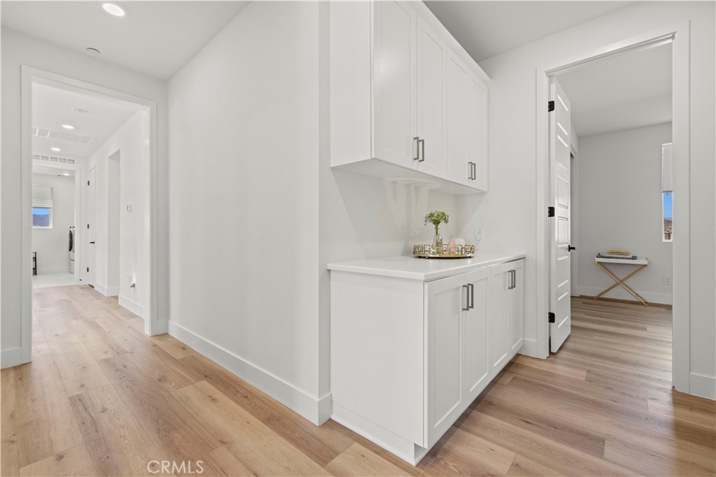 30015 Chestnut Lane Castaic, CA 91384 - Photo 35 of 60 a hallway with white cabinets and wooden floor