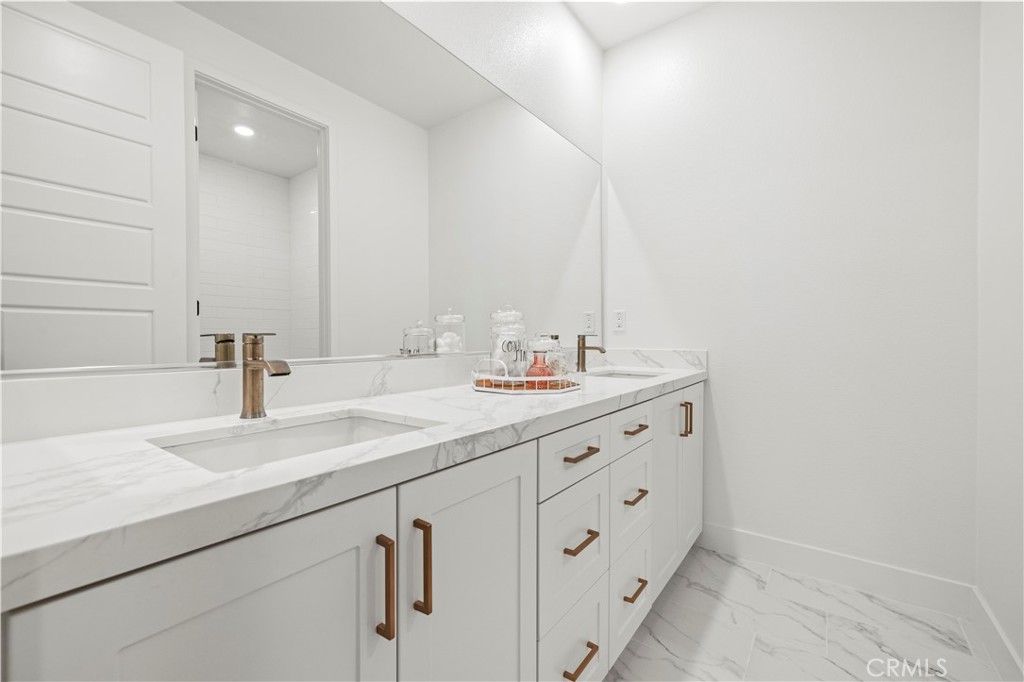 30015 Chestnut Lane Castaic, CA 91384 - Photo 37 of 60 a bathroom with a double vanity sink and mirror