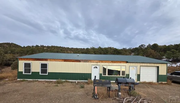 a view of house with yard and lake view
