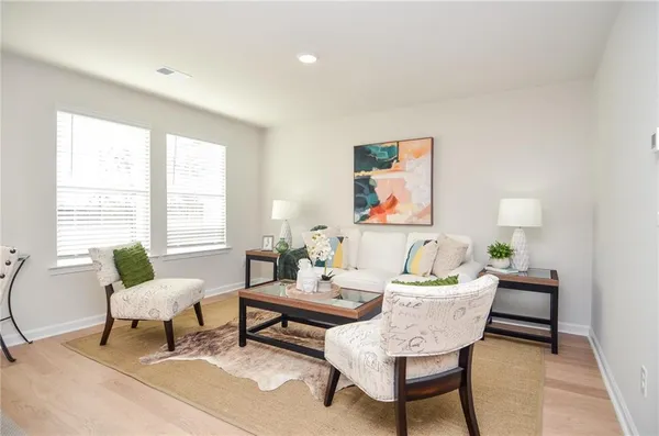 a living room with furniture and a large window