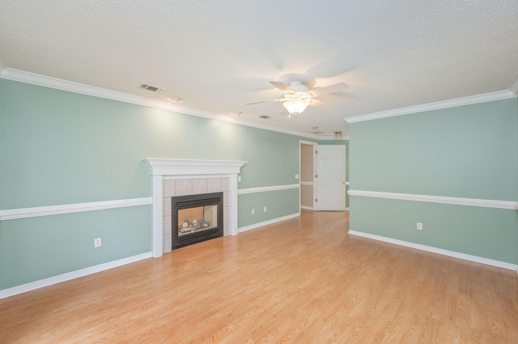 734 Riva Ridge Drive Crestview, FL 32539 - Photo 19 of 53 a view of an empty room with a fireplace and a window