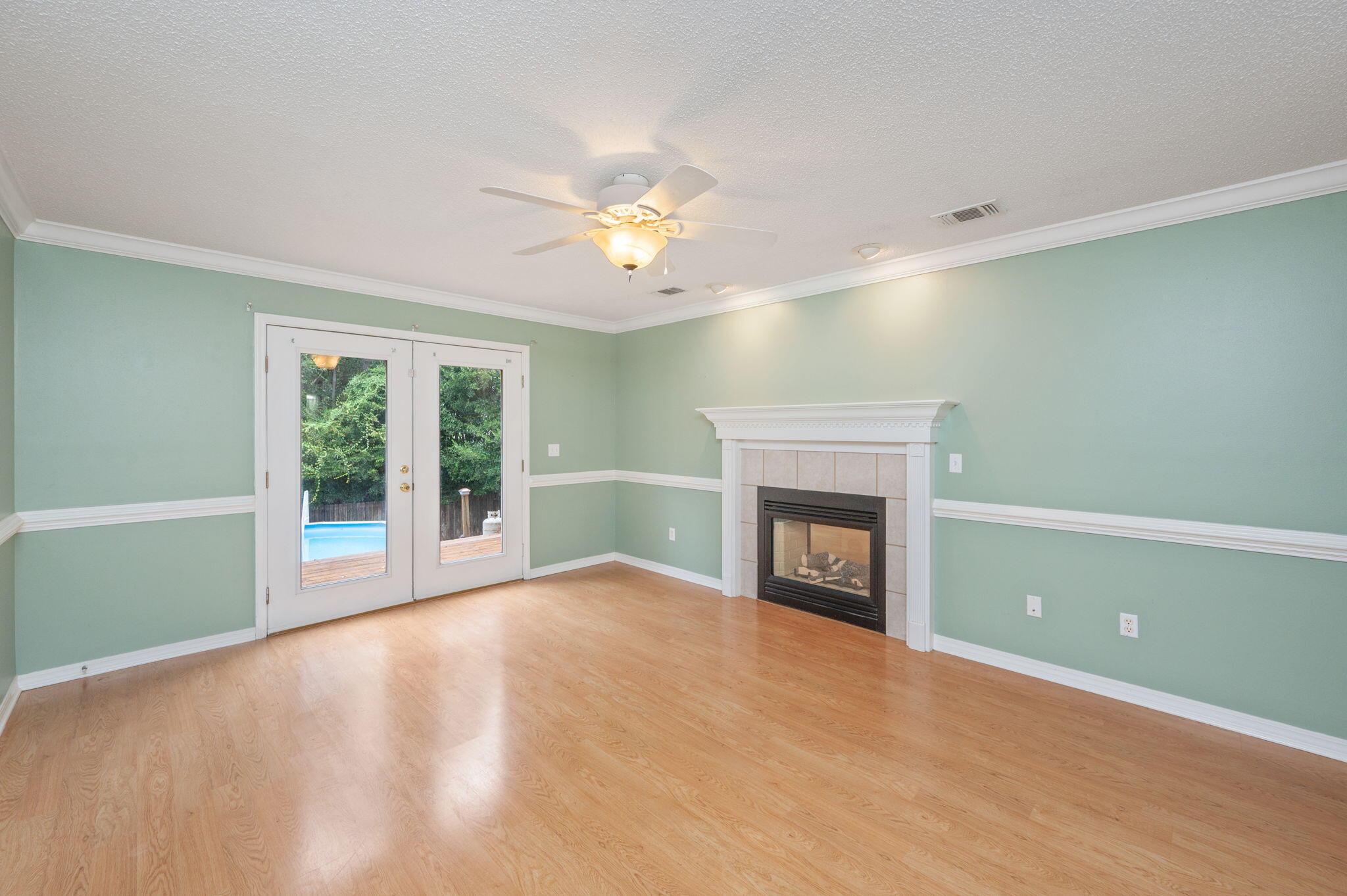 734 Riva Ridge Drive Crestview, FL 32539 - Photo 20 of 53 a view of an empty room with a fireplace and a window