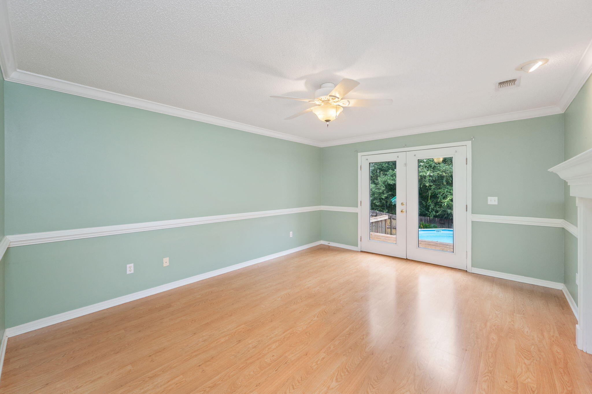 734 Riva Ridge Drive Crestview, FL 32539 - Photo 21 of 53 an empty room with wooden floor and windows