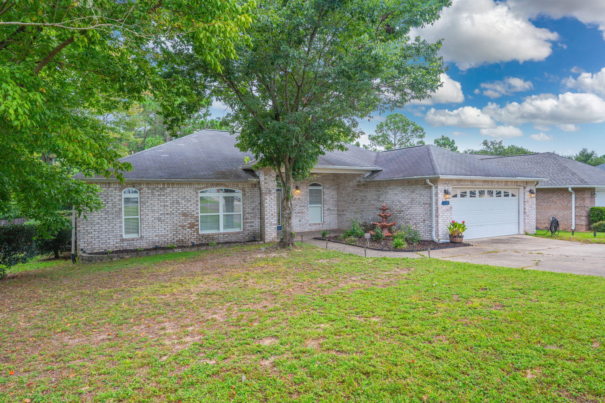 734 Riva Ridge Drive Crestview, FL 32539 - Photo 4 of 53 a front view of a house with a garden and tree