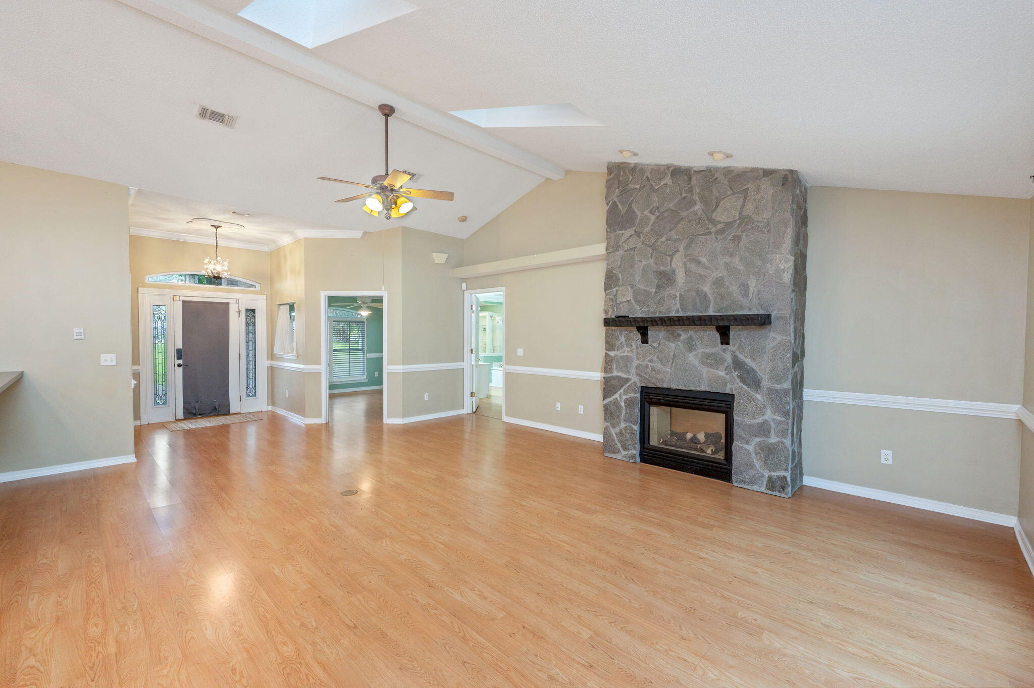 734 Riva Ridge Drive Crestview, FL 32539 - Photo 8 of 53 a view of an empty room with fire place and a kitchen island
