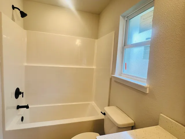 a bathroom with a bathtub and a shower