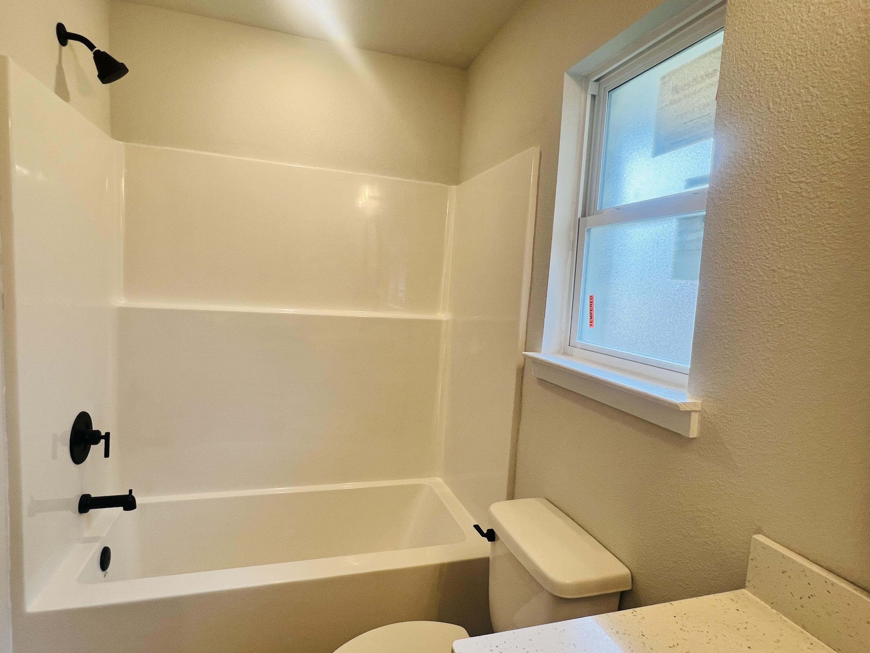 5295 Hidden Pines Circle Milton, FL 32583 - Photo 11 of 16 a bathroom with a bathtub and a shower