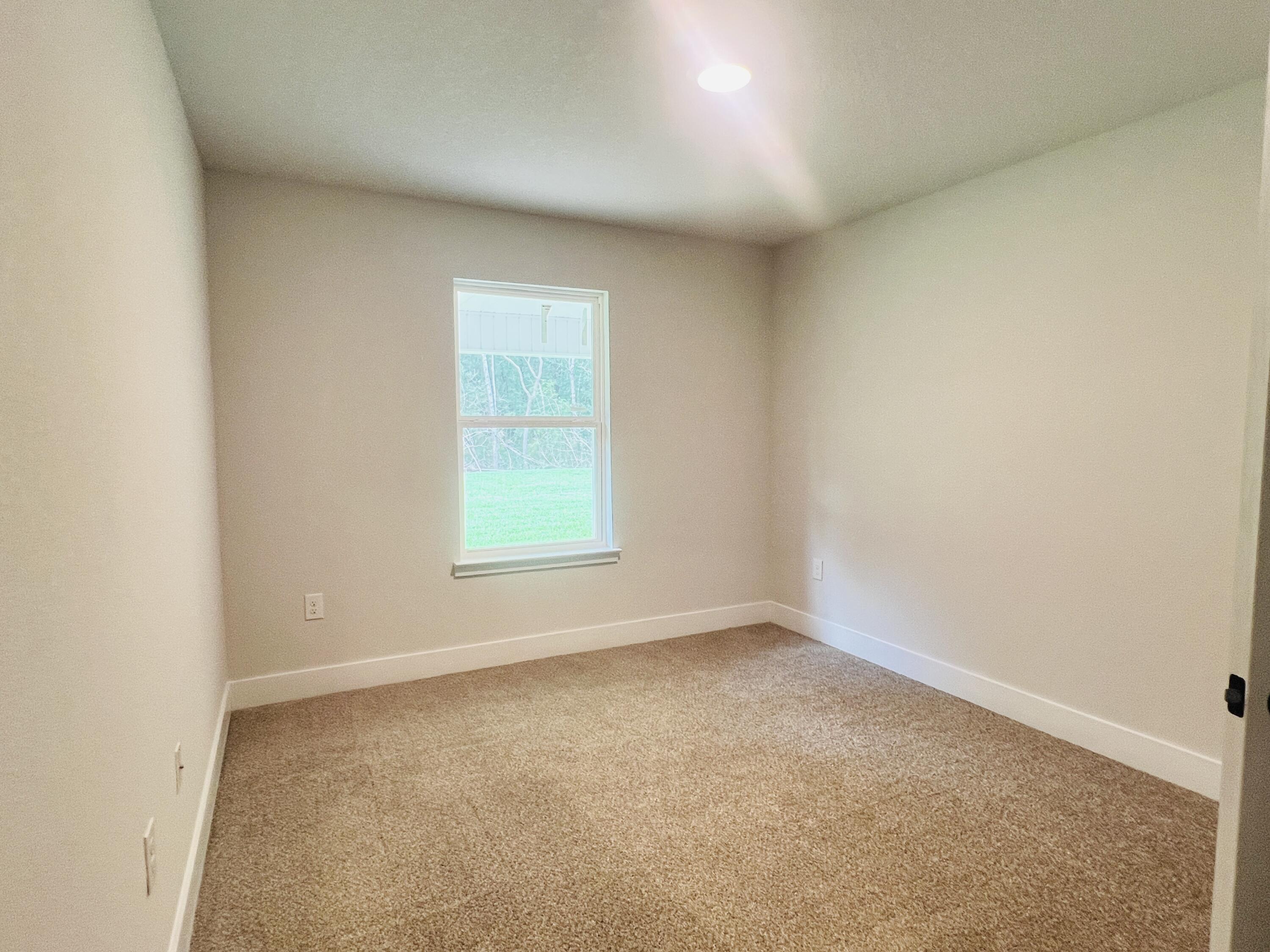 5295 Hidden Pines Circle Milton, FL 32583 - Photo 13 of 16 an empty room with a window