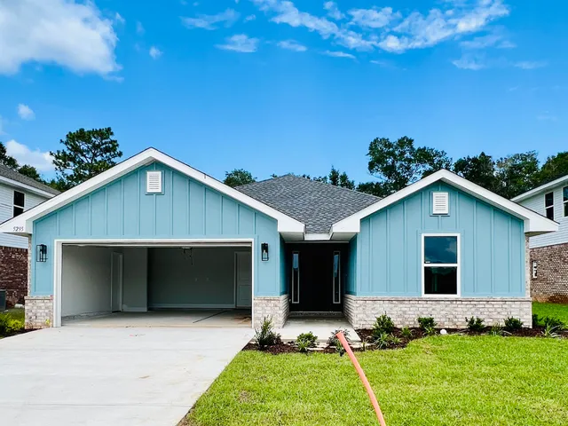 a front view of house with yard and green space