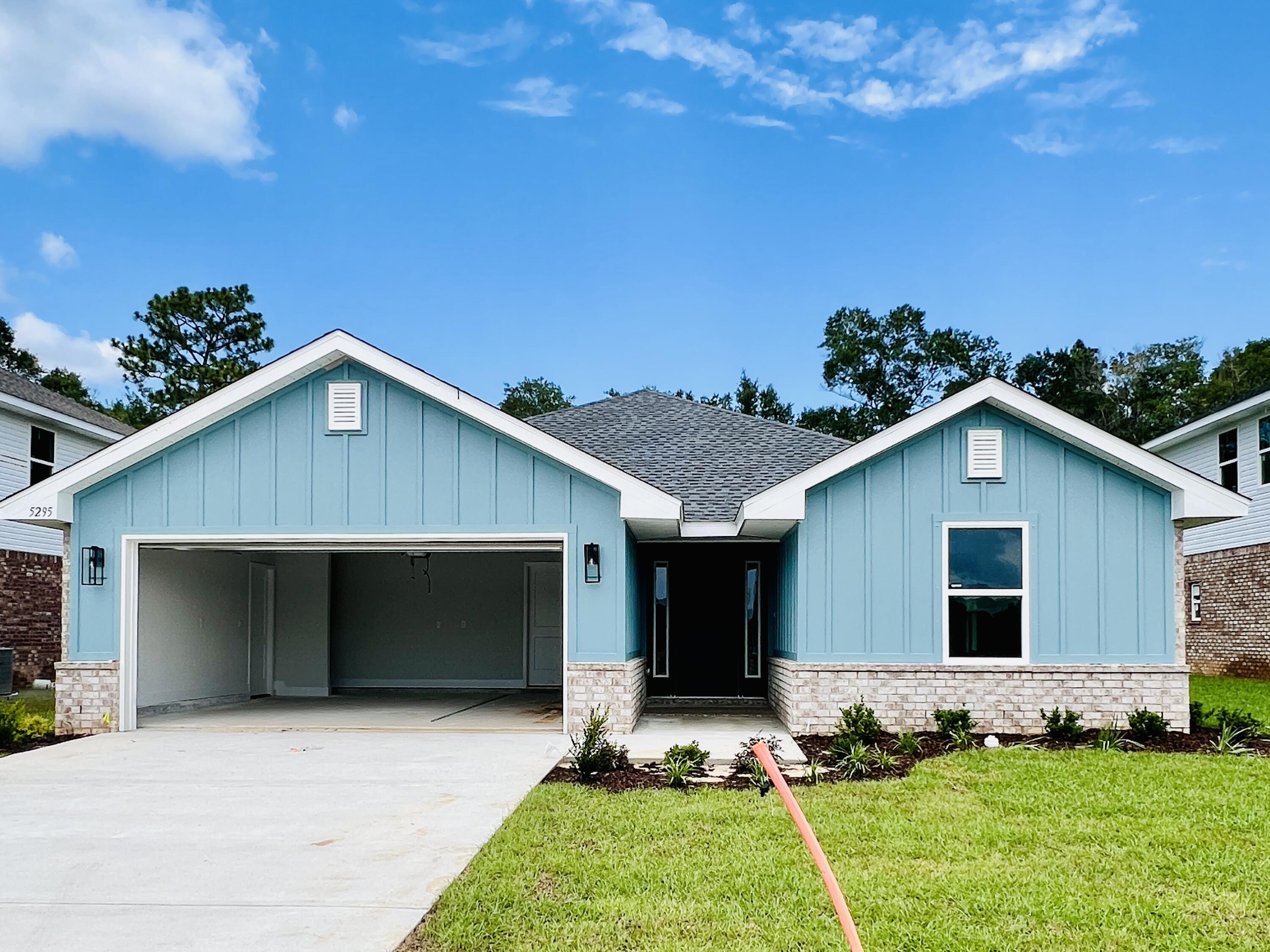 5295 Hidden Pines Circle Milton, FL 32583 - Photo 2 of 16 a front view of house with yard and green space