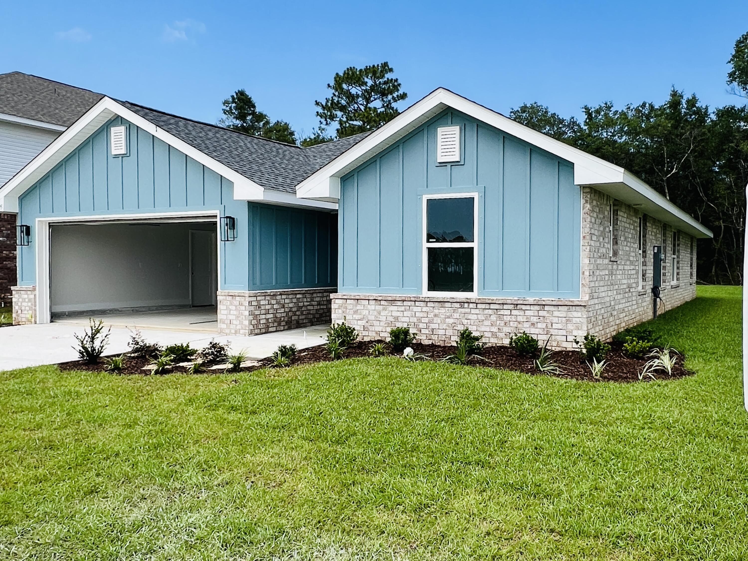 5295 Hidden Pines Circle Milton, FL 32583 - Photo 3 of 16 a front view of house with yard