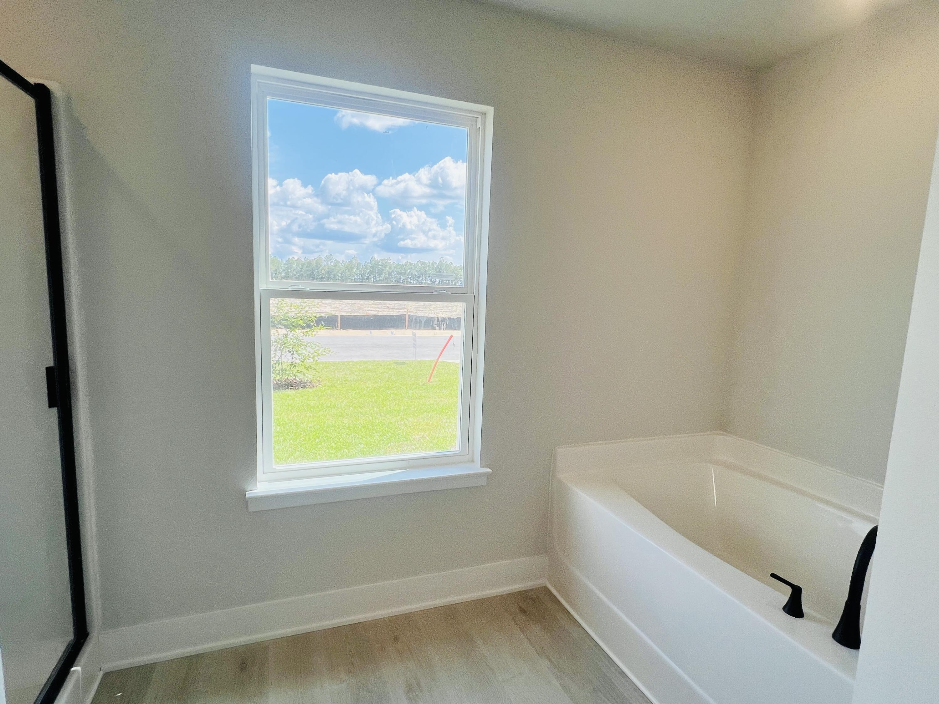 5295 Hidden Pines Circle Milton, FL 32583 - Photo 6 of 16 a bathroom with a tub and a window